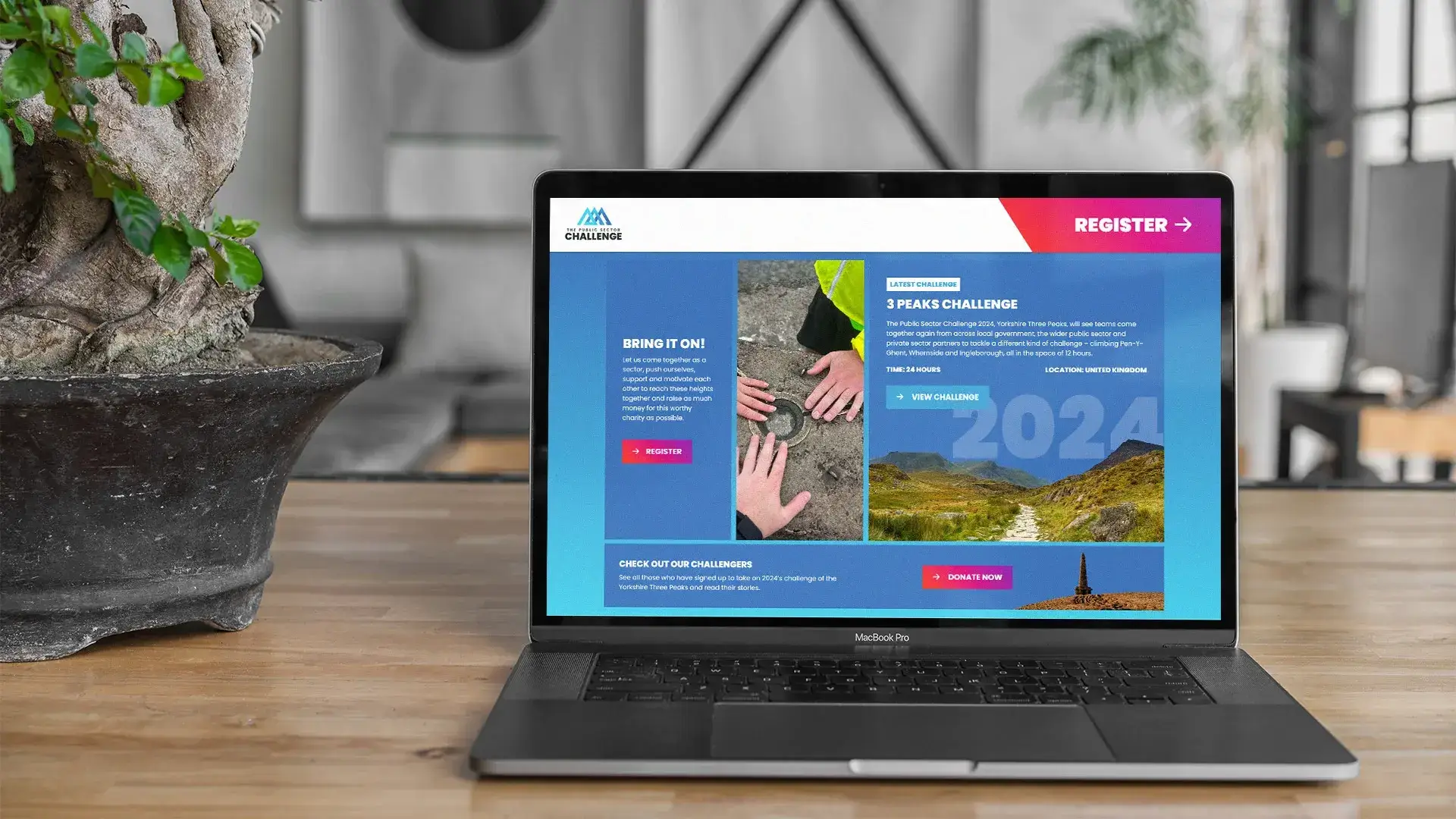 Open laptop showing the homepage of the Public Sector Challenge website where it describes the challenge and encourages people to register
